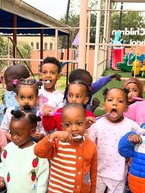 Children brushing teeth together